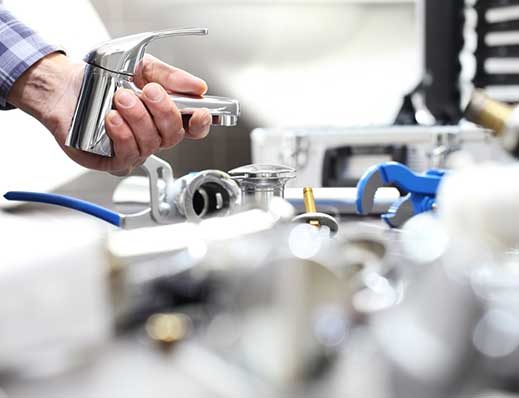 A Man Holding a Faucet, Ready for Installation — Professional Plumbing Services in Forestville, NSW