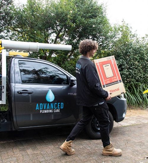 A Plumber Holding Rinnai Box in Sydney, NSW