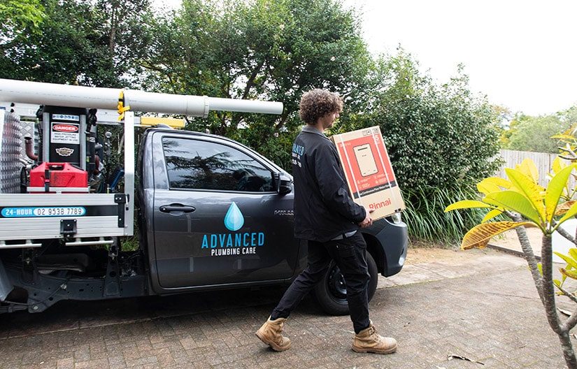 A Plumber Holding Rinnai Box in Sydney, NSW